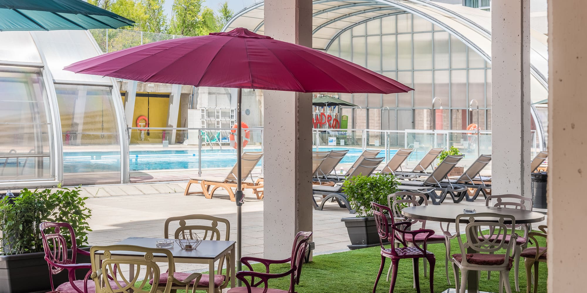 a patio area with chairs and umbrellas