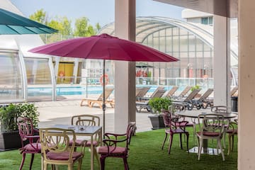 a patio area with chairs and umbrellas