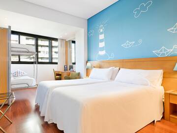 a room with two beds and a wall with a lighthouse painted on the wall