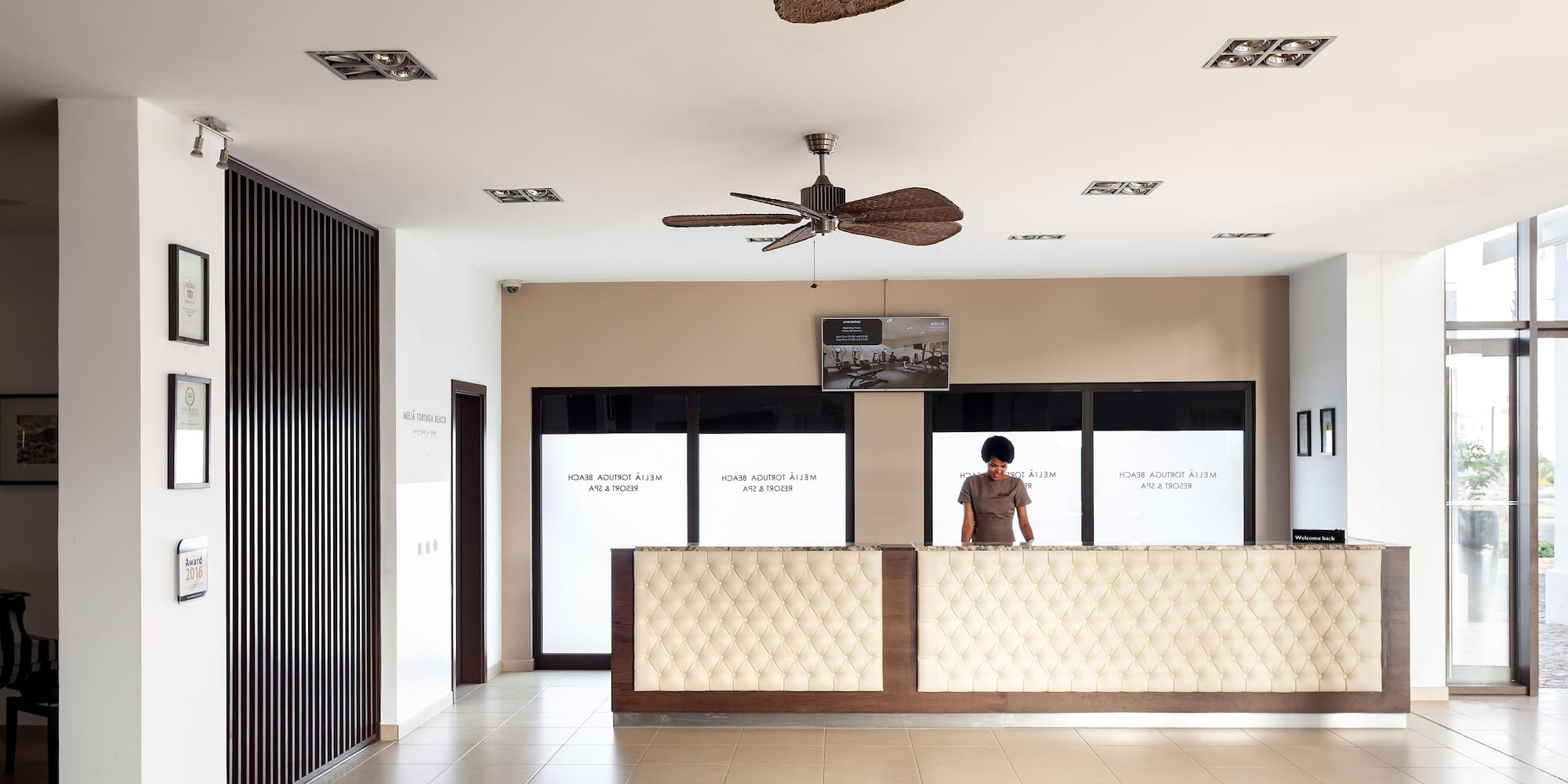 a person standing behind a reception desk
