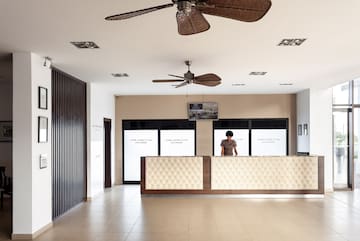 a person standing behind a reception desk