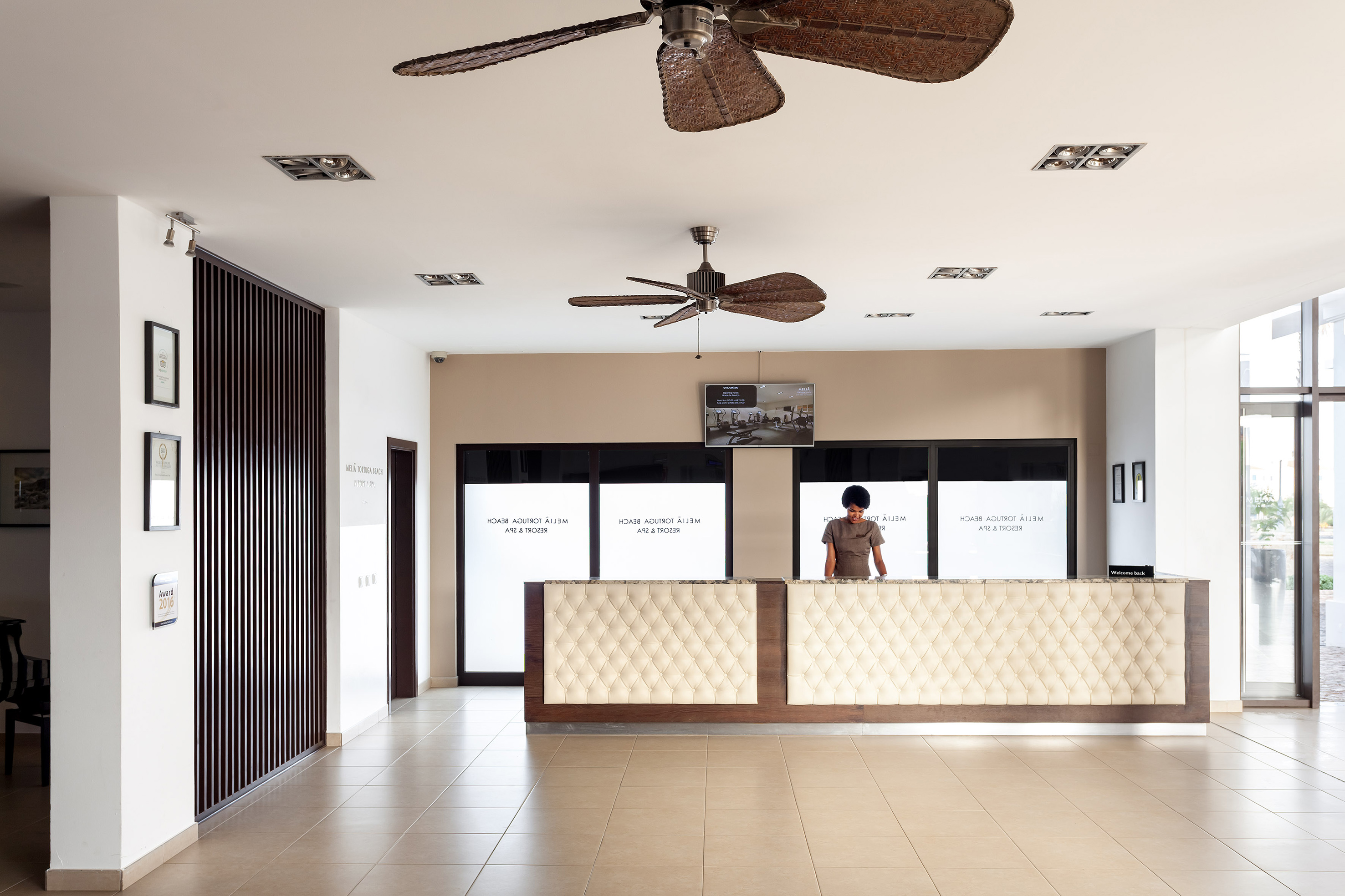 a person standing behind a reception desk