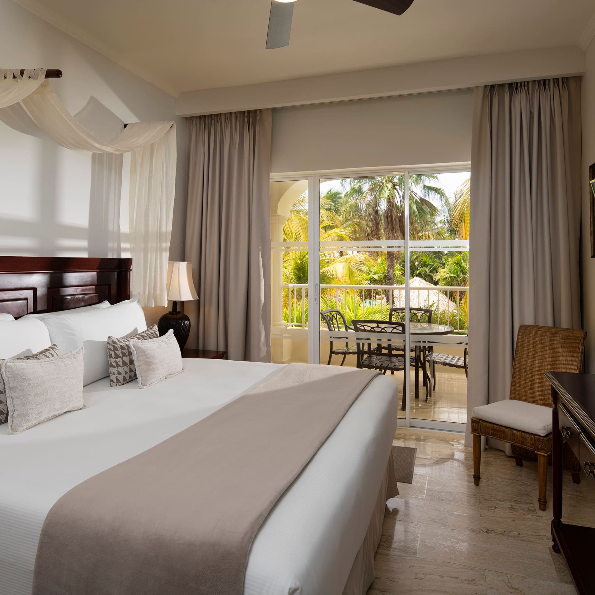 a bedroom with a large bed and a desk