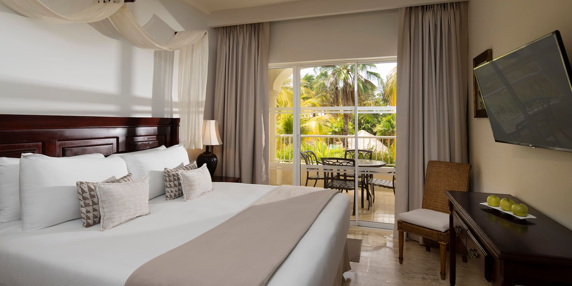 a bedroom with a large bed and a desk