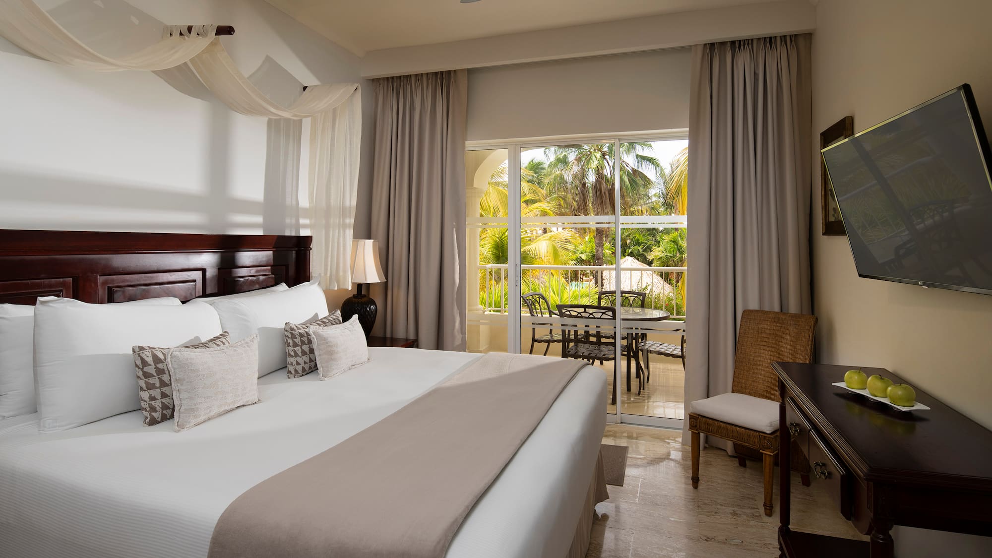 a bedroom with a large bed and a desk