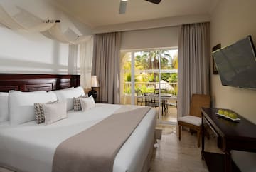 a bedroom with a large bed and a desk