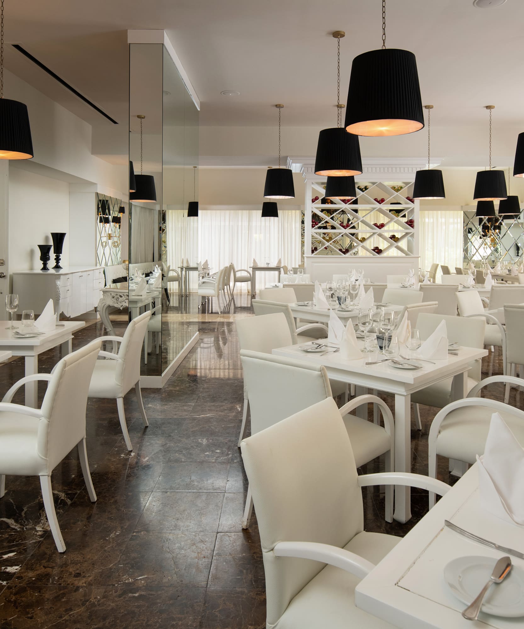 a room with white tables and chairs