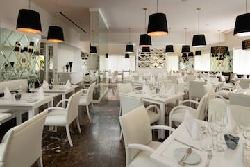 a room with white tables and chairs