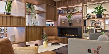a room with a fireplace and chairs