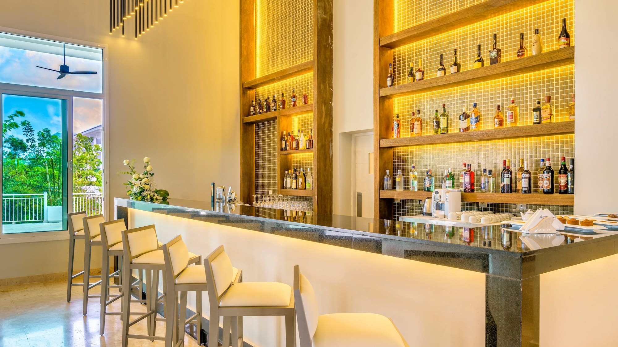 a bar with bottles of alcohol on shelves