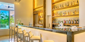 a bar with bottles of alcohol on shelves