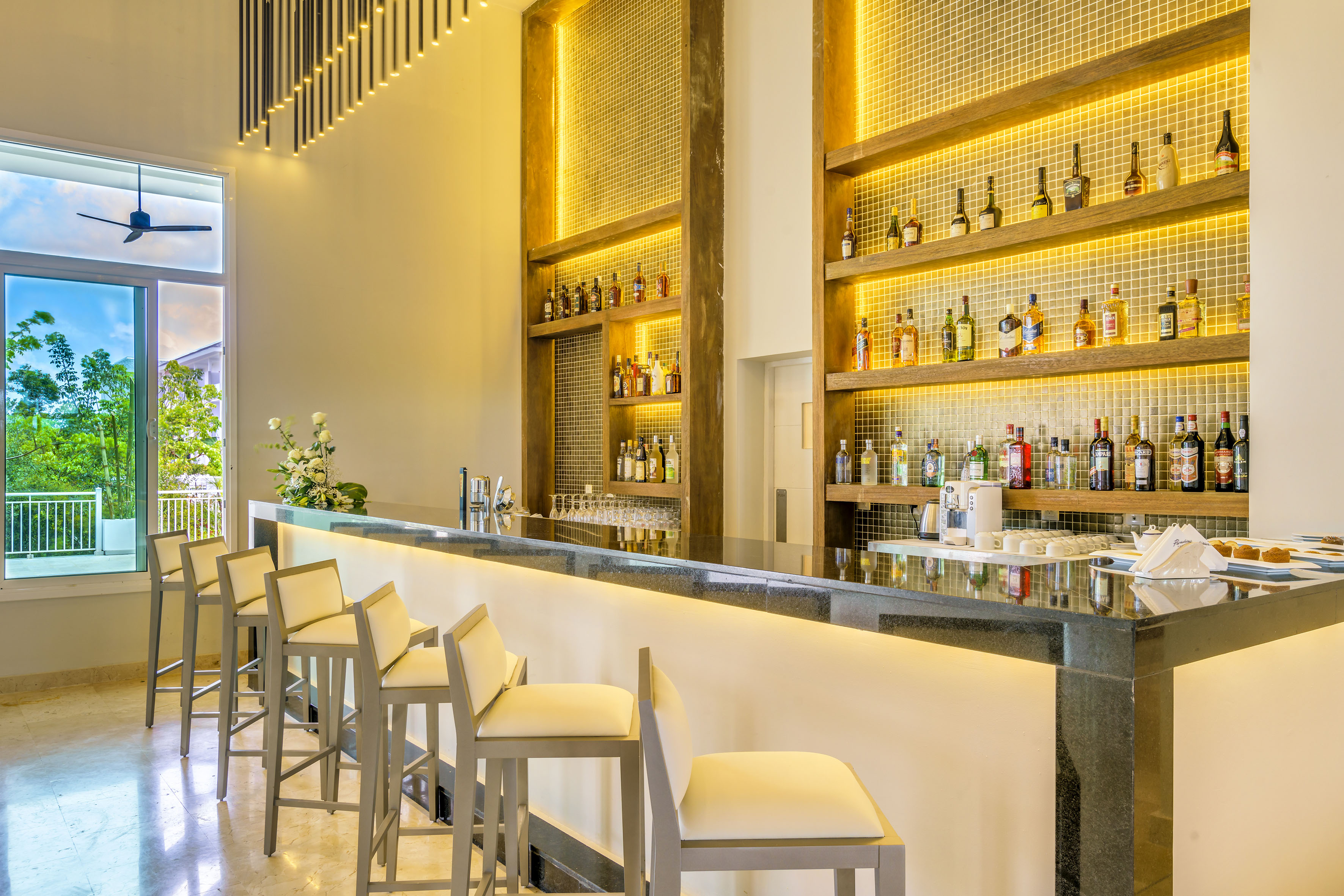 a bar with bottles of alcohol on shelves