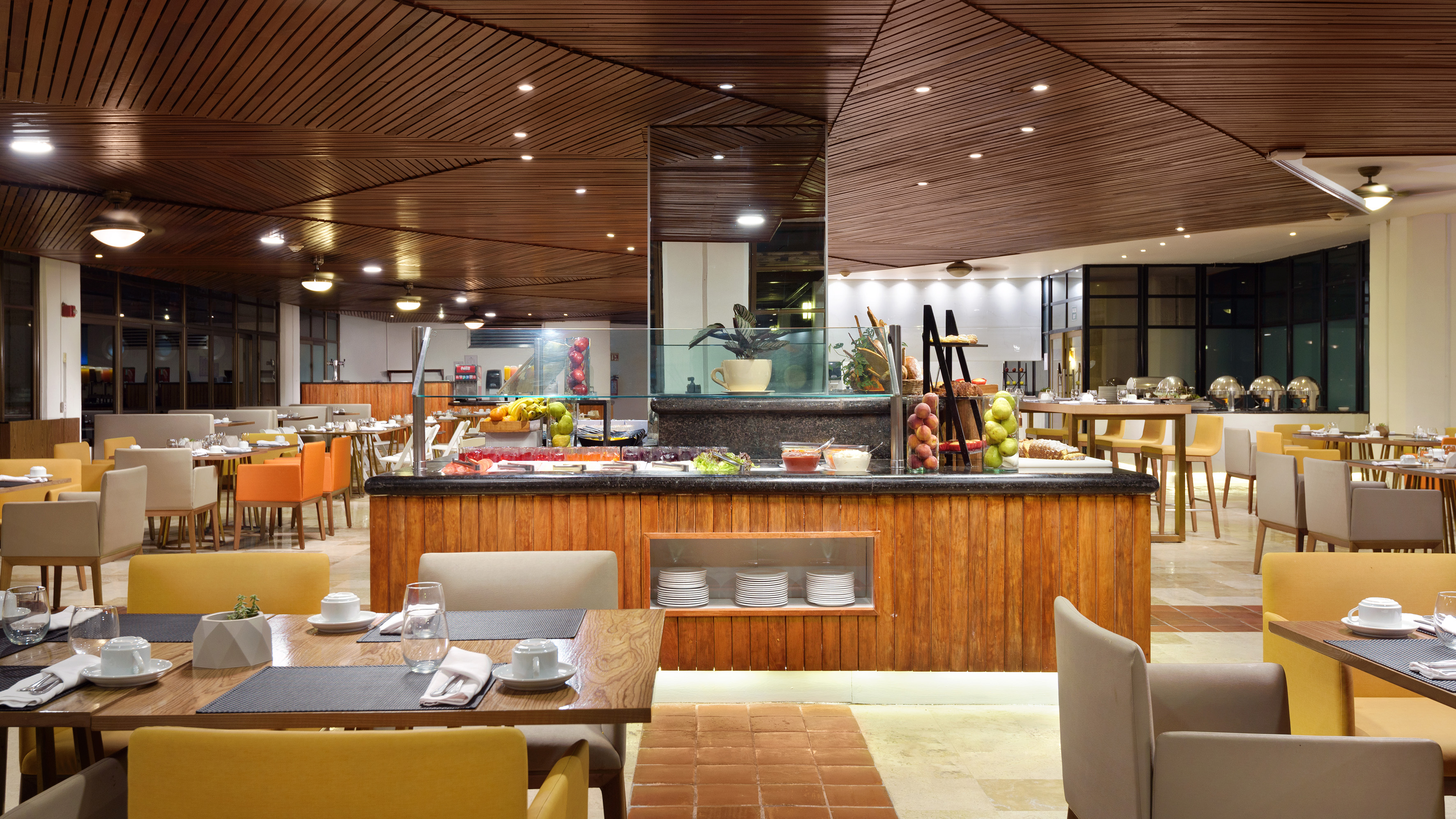 a restaurant with a buffet table and chairs