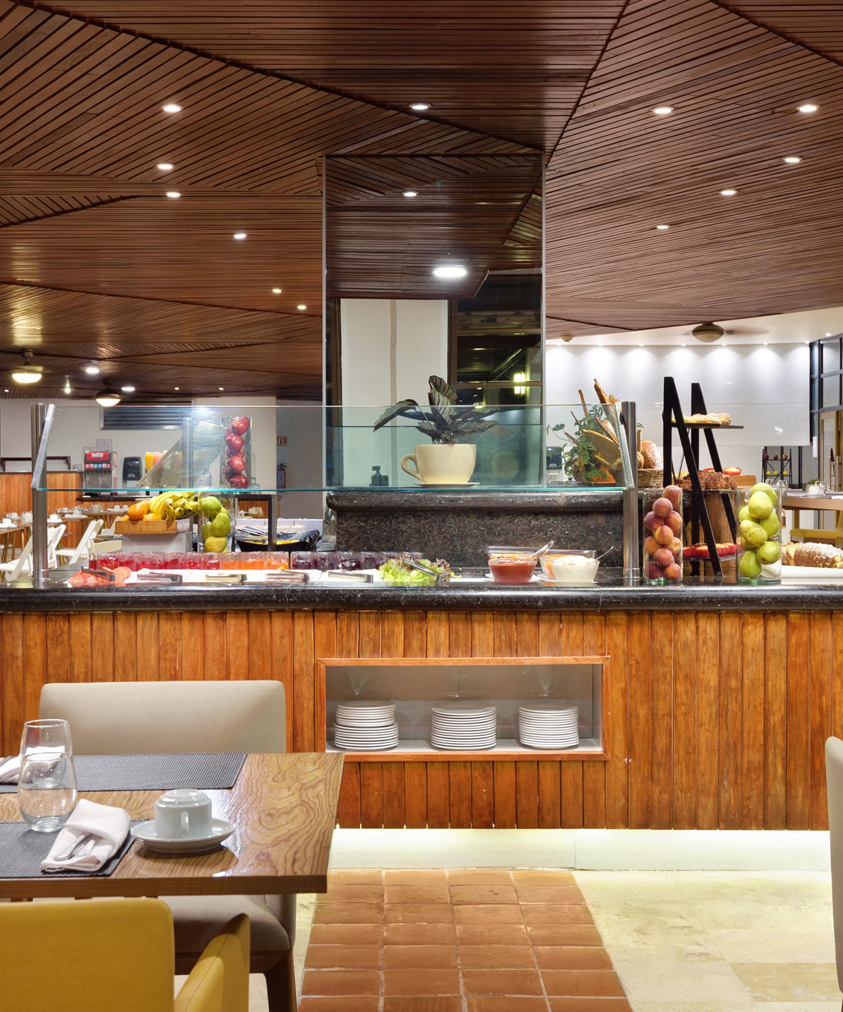 a restaurant with a buffet table and chairs