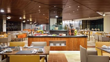 a restaurant with a buffet table and chairs