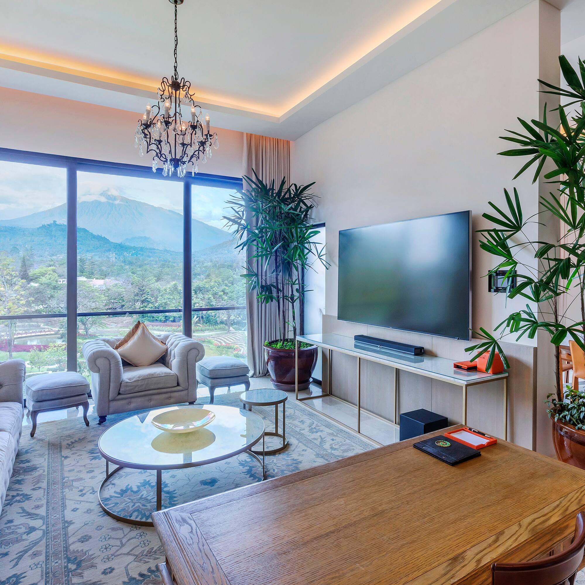 a living room with a large window and a television