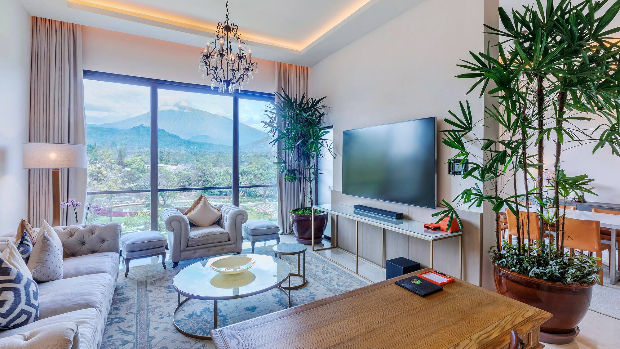 a living room with a large window and a television