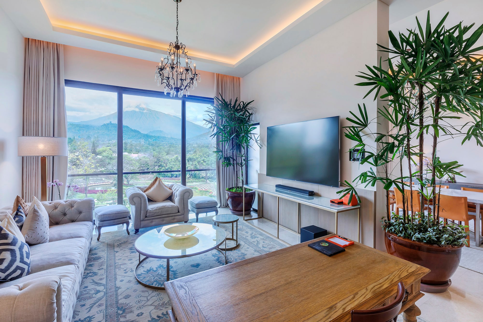 a living room with a large window and a television