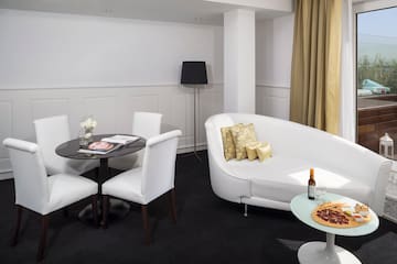 a room with white couches and pizza