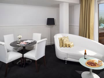 a room with white couches and pizza