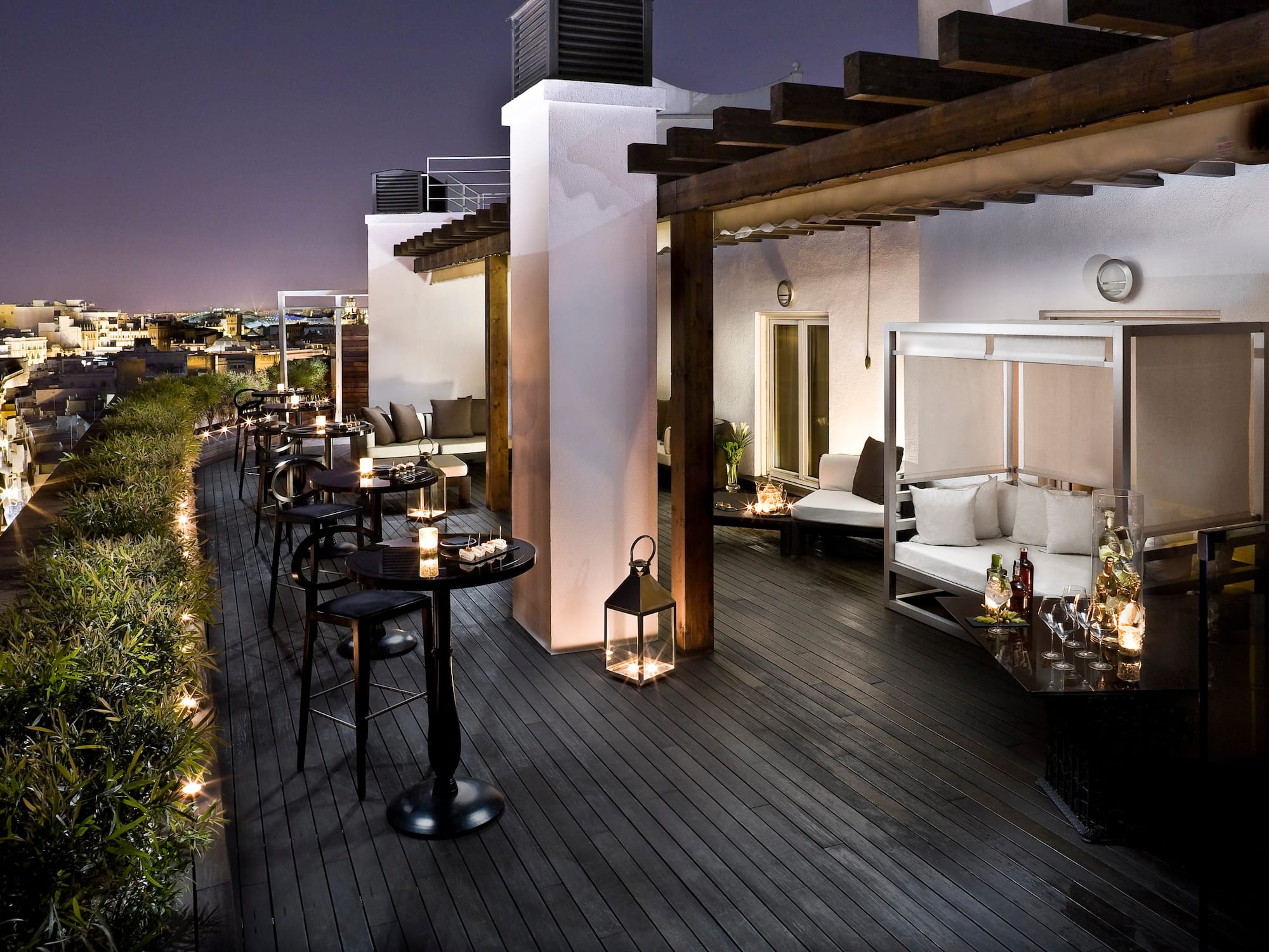 a patio with tables and chairs on a deck