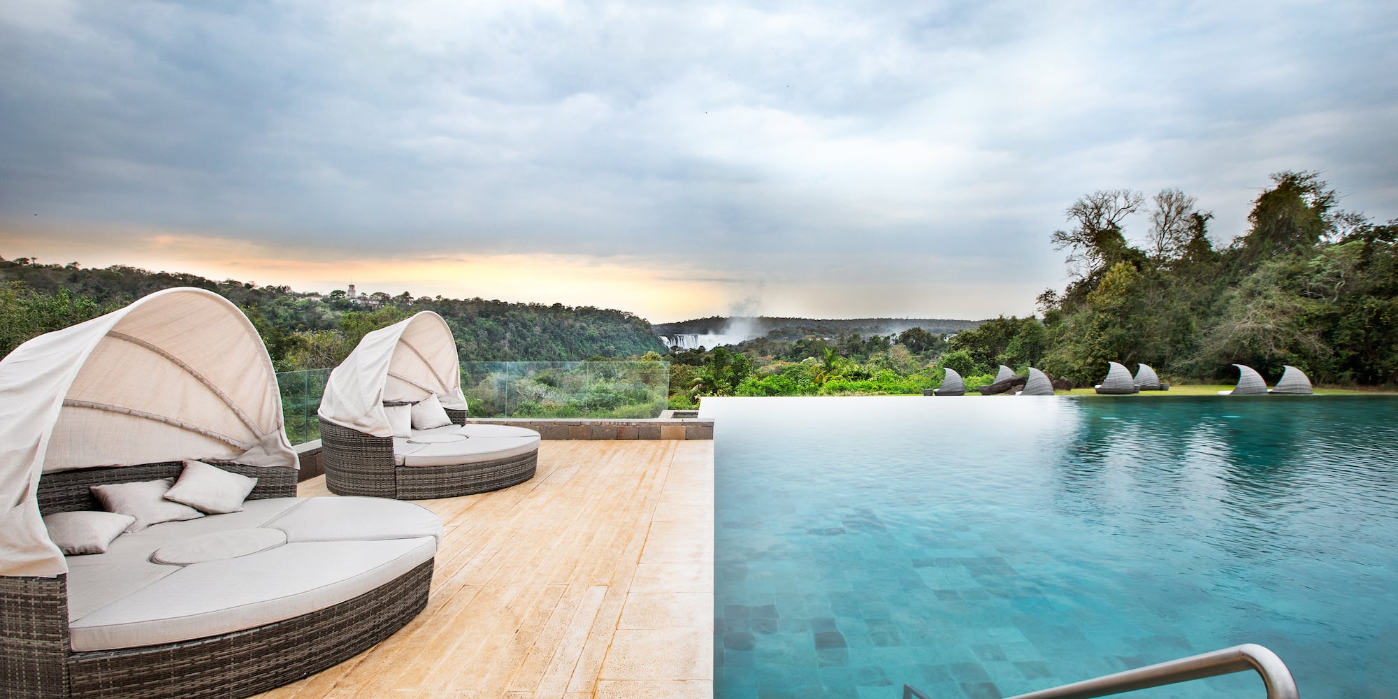 a pool with a deck and chairs