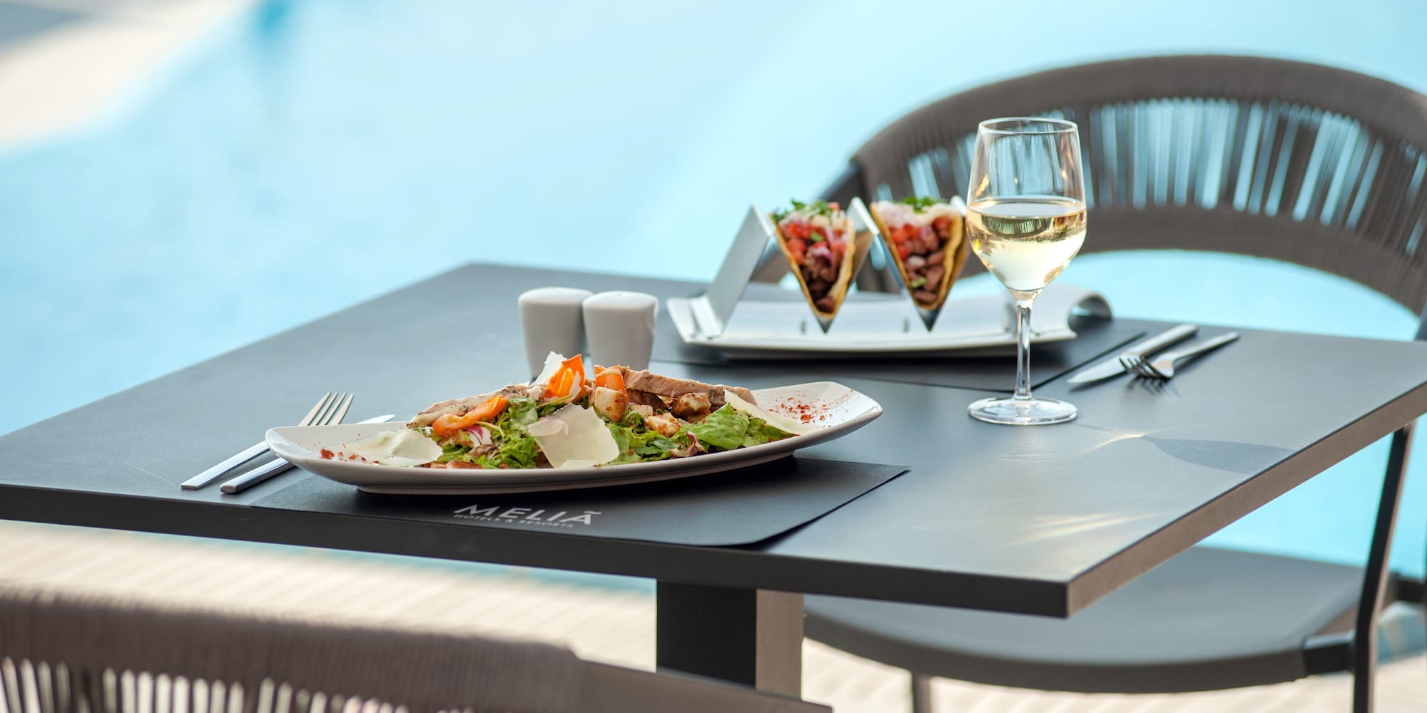 a table with food and a glass of wine