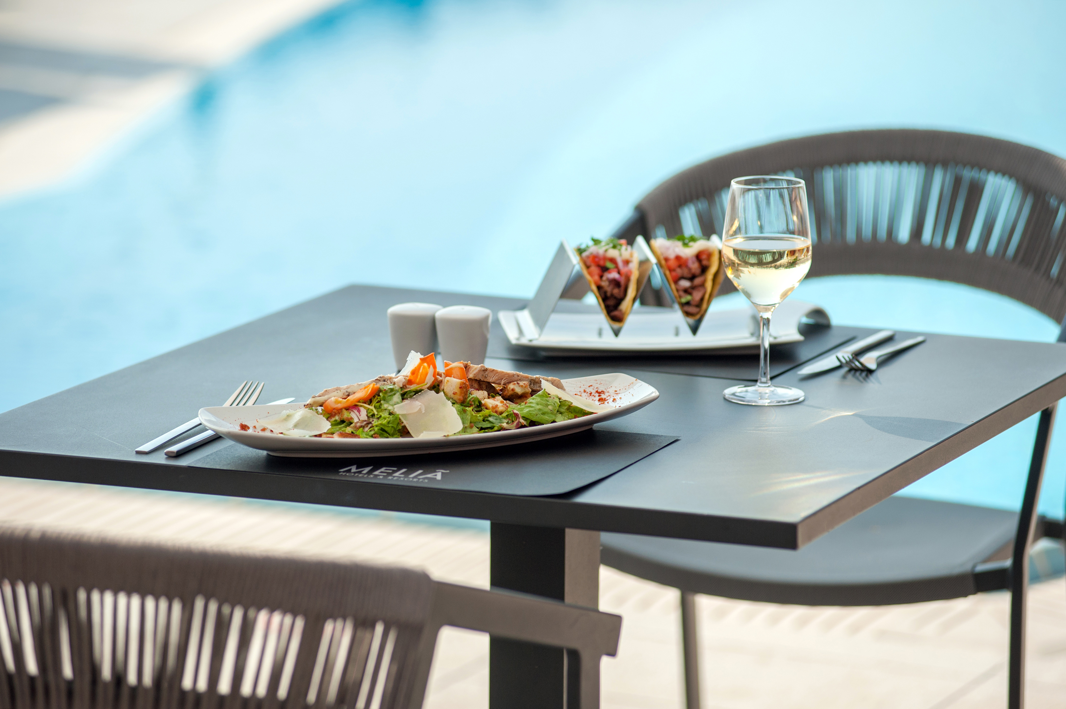 a table with food and a glass of wine