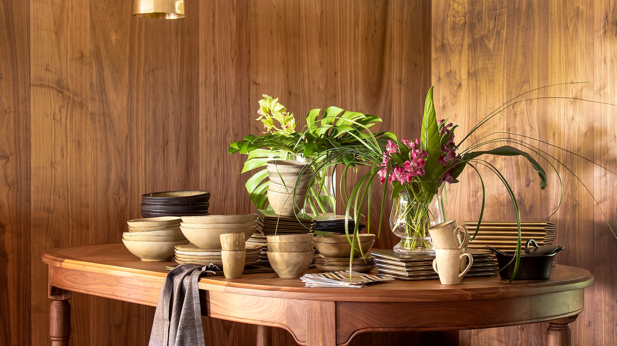 a table with plates and potted plants on it