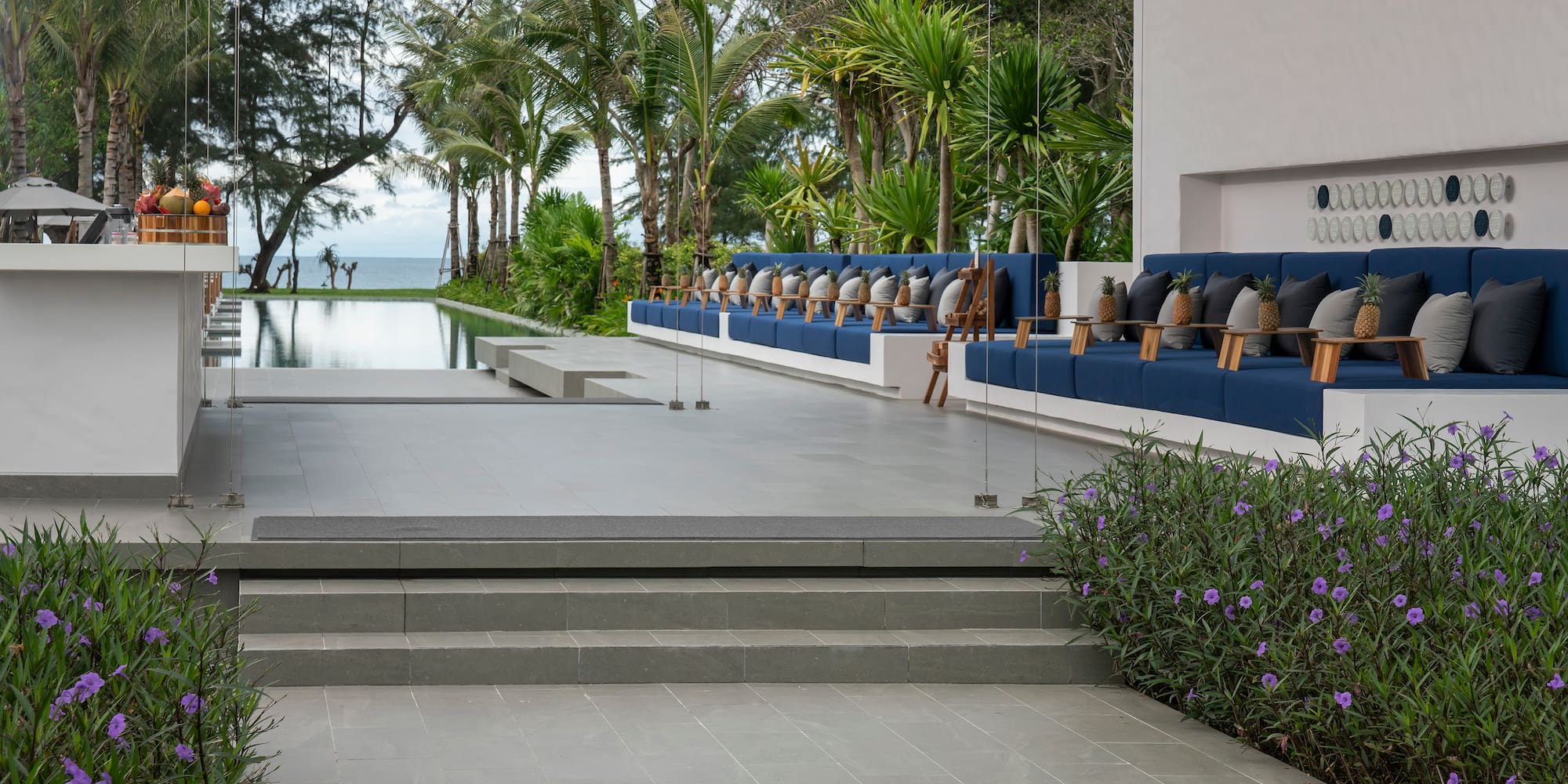 a pool with a row of chairs and trees
