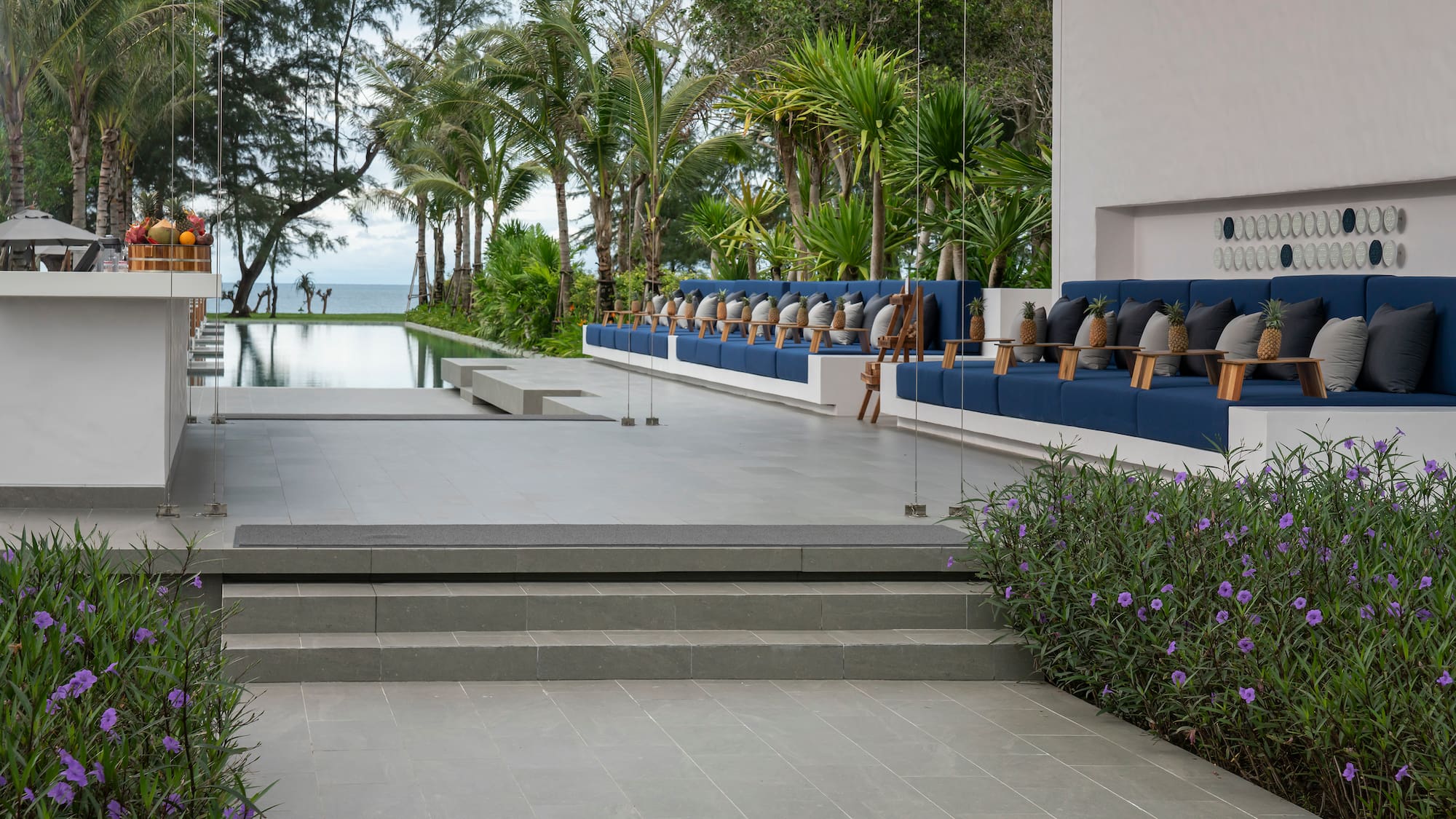 a pool with a row of chairs and trees