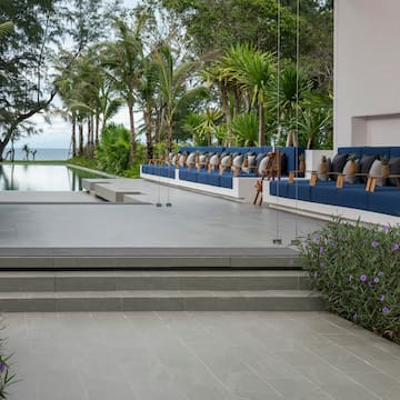 a pool with a row of chairs and trees