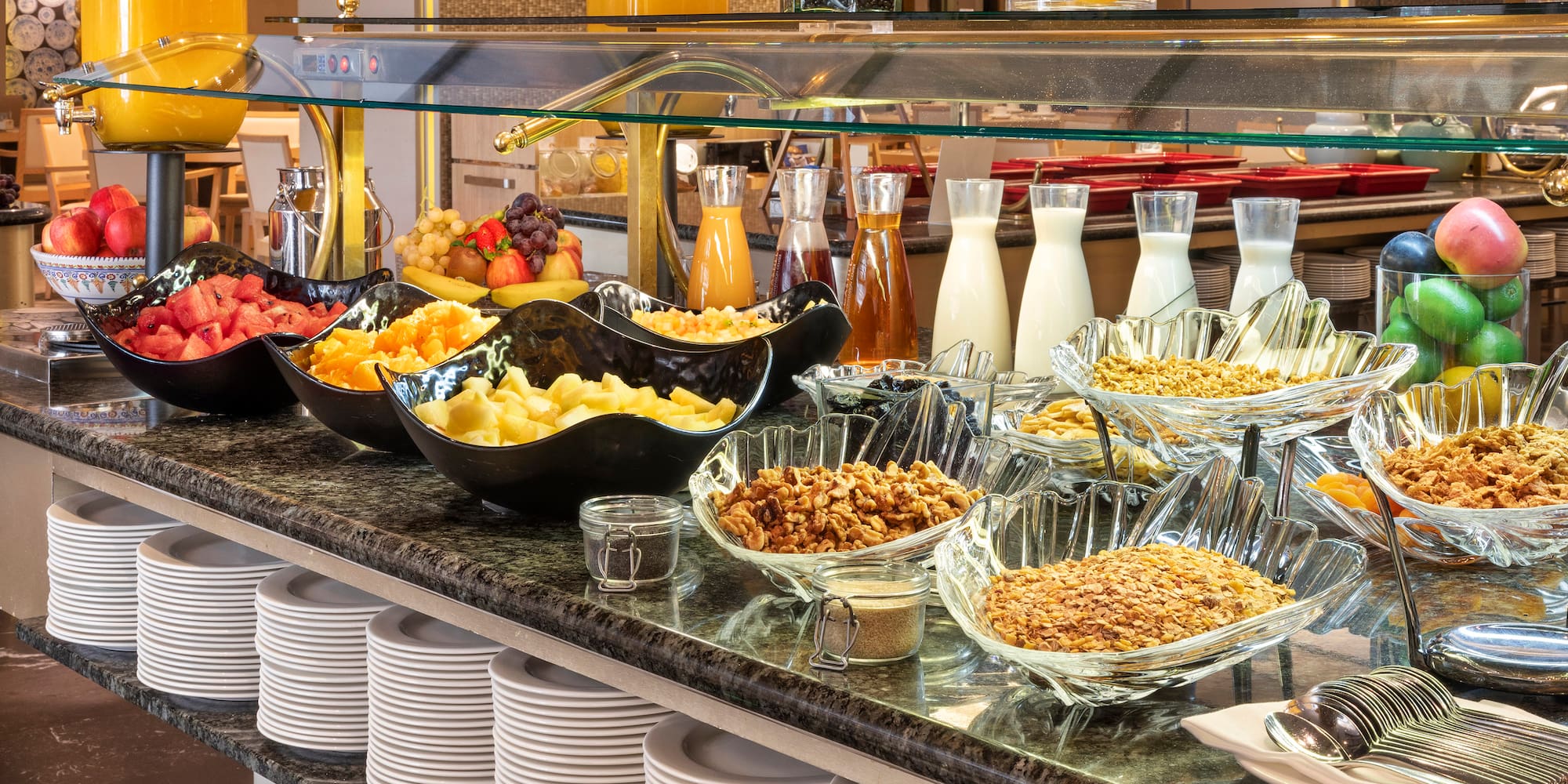 a buffet with plates of food and drinks