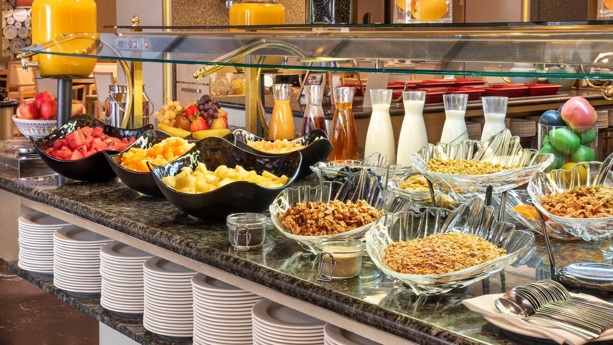 a buffet with plates of food and drinks