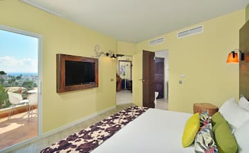 a room with a bed and a television on the wall