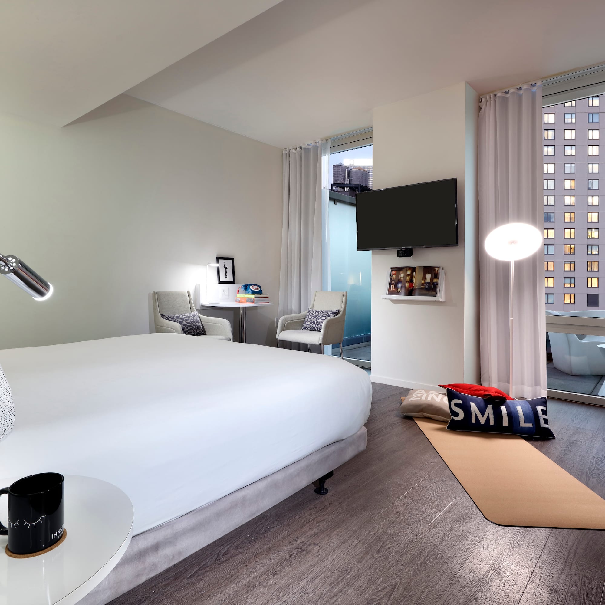 a bedroom with a bed and a television