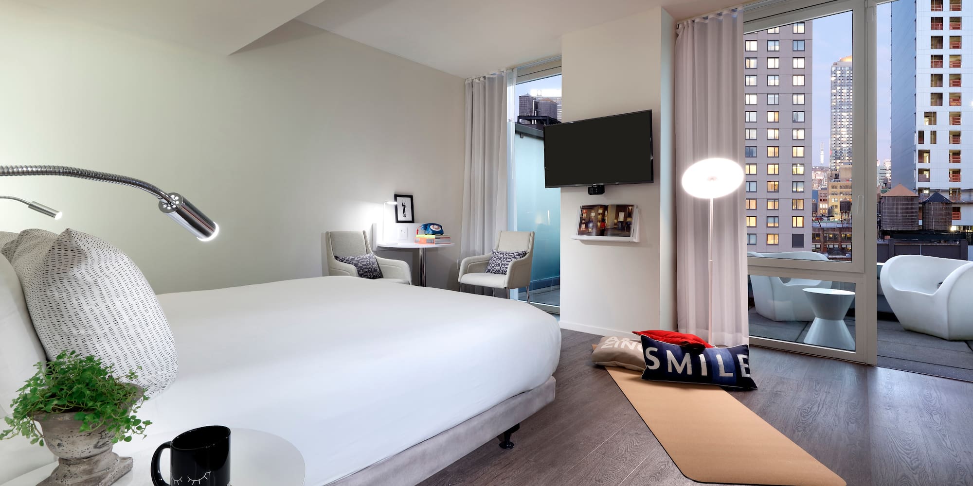 a bedroom with a bed and a television