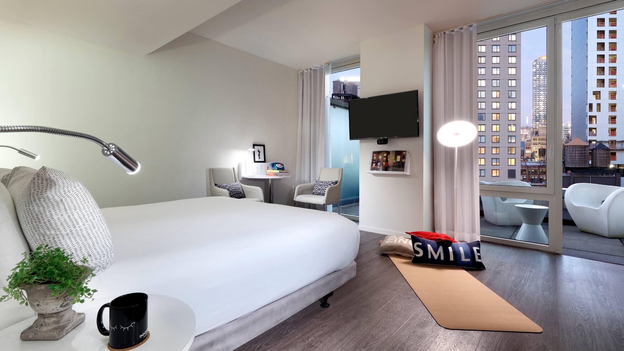 a bedroom with a bed and a television