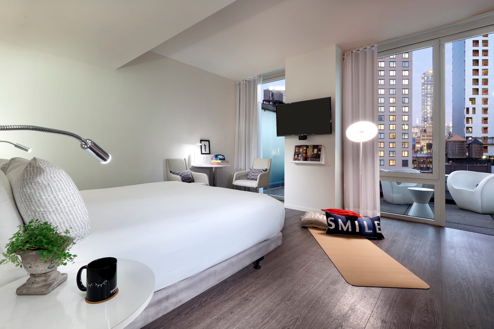 a bedroom with a bed and a television