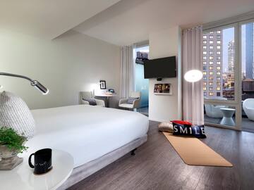 a bedroom with a bed and a television