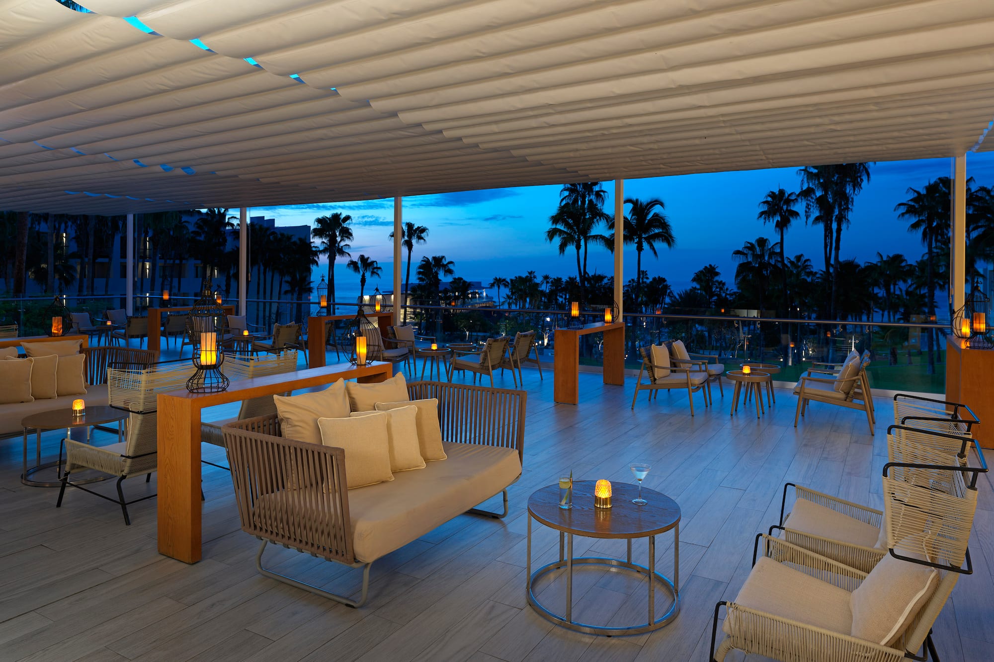 a room with a table and chairs and a table with candles