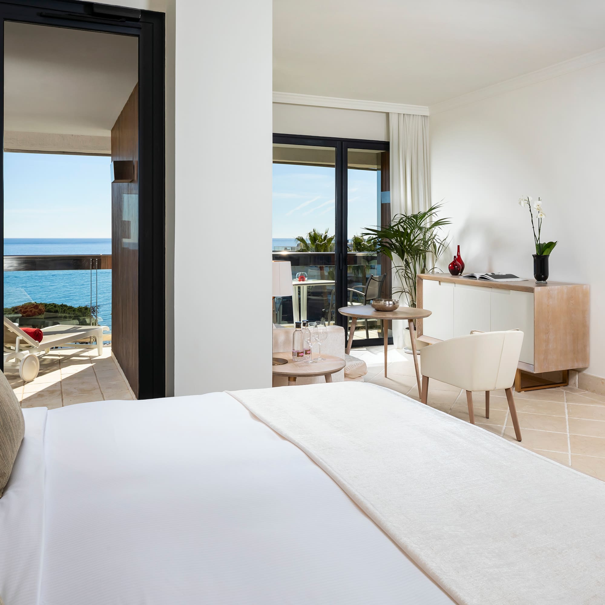 a bedroom with a large bed and a glass door