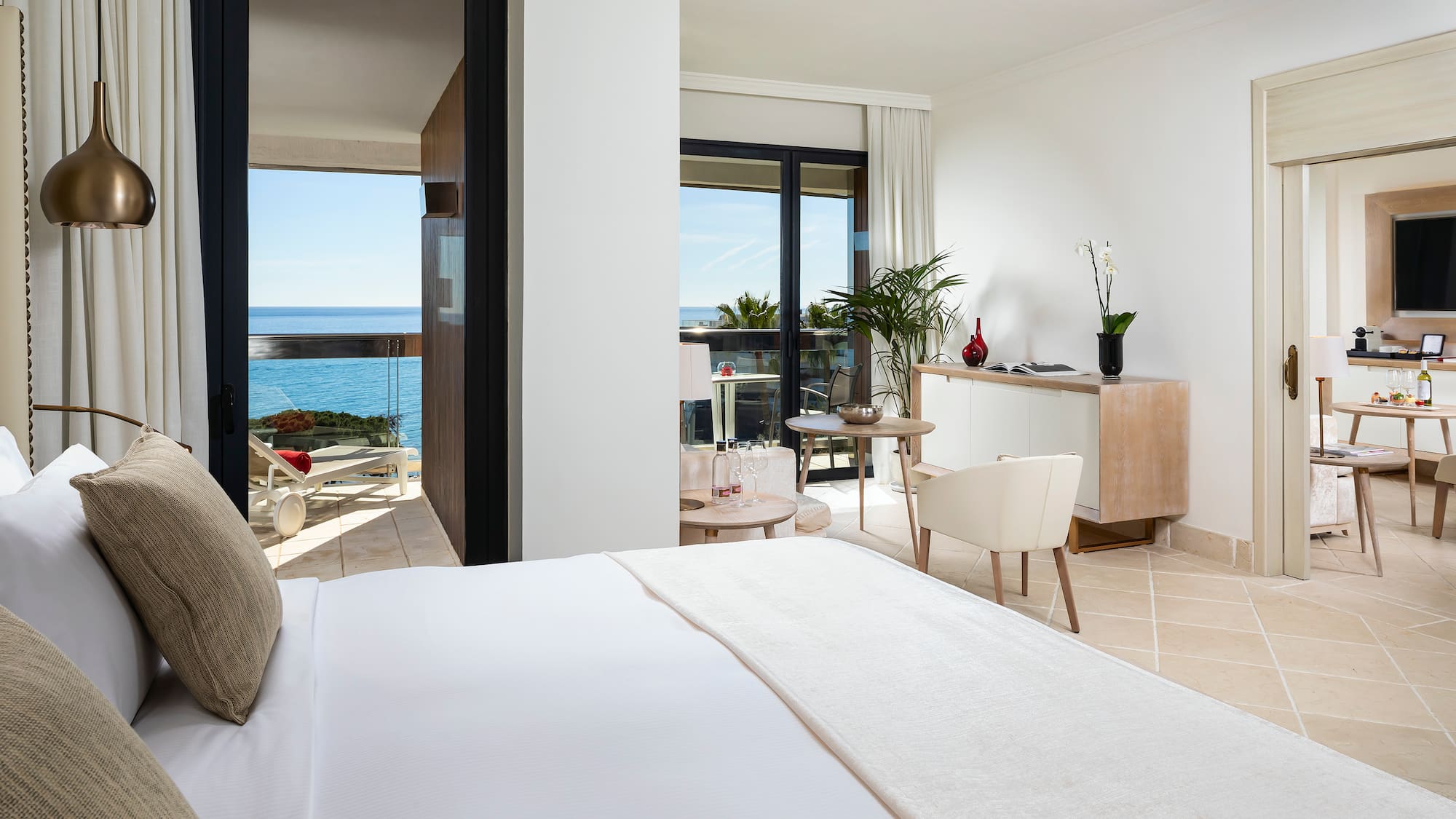 a bedroom with a large bed and a glass door