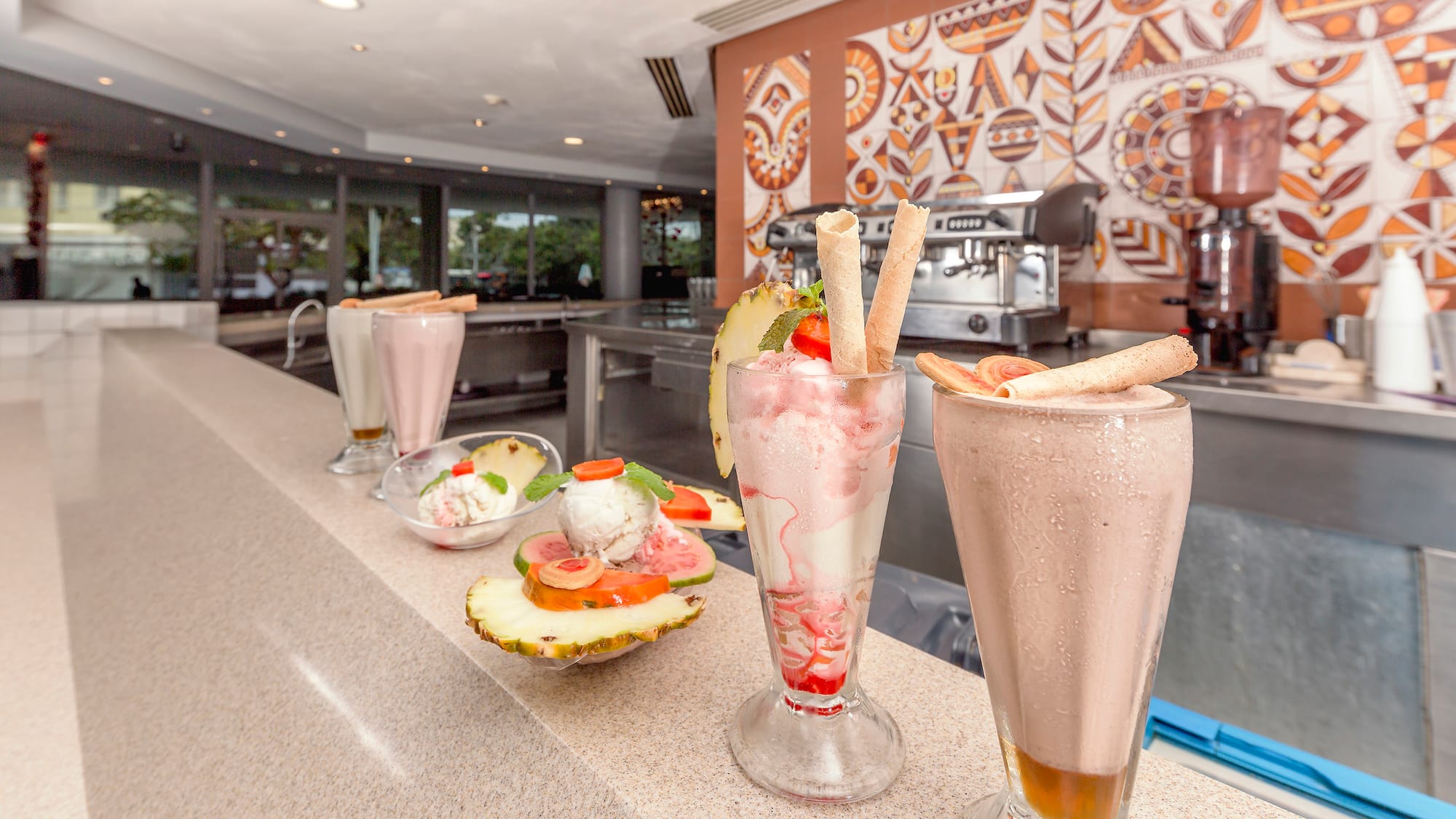 a group of glasses with food on a counter