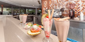 a group of glasses with food on a counter