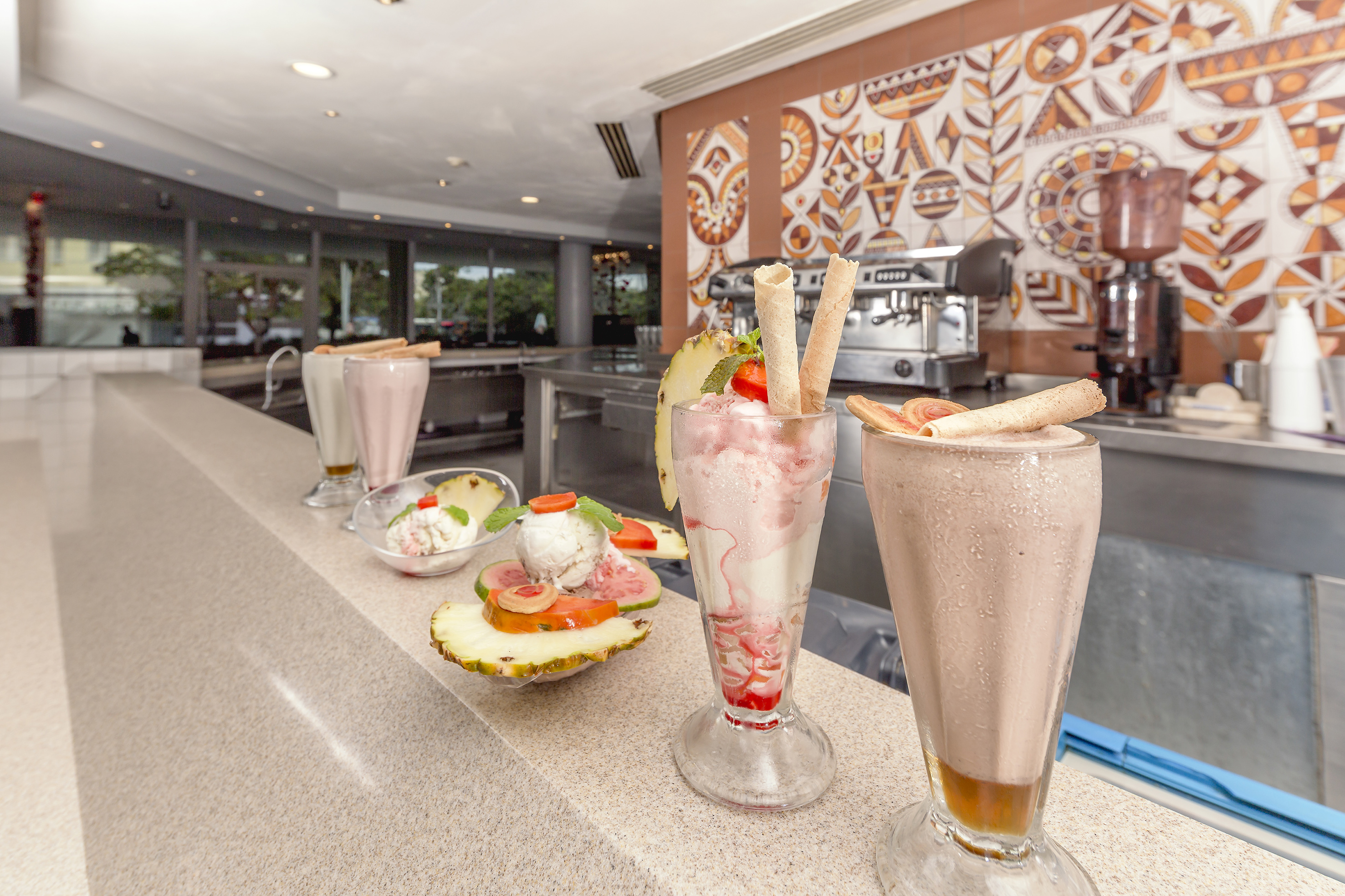 a group of glasses with food on a counter