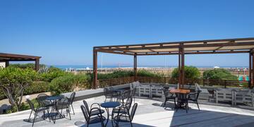 a patio with chairs and tables