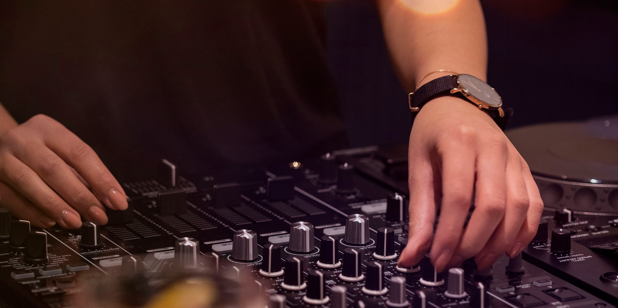 a person playing music on a mixer