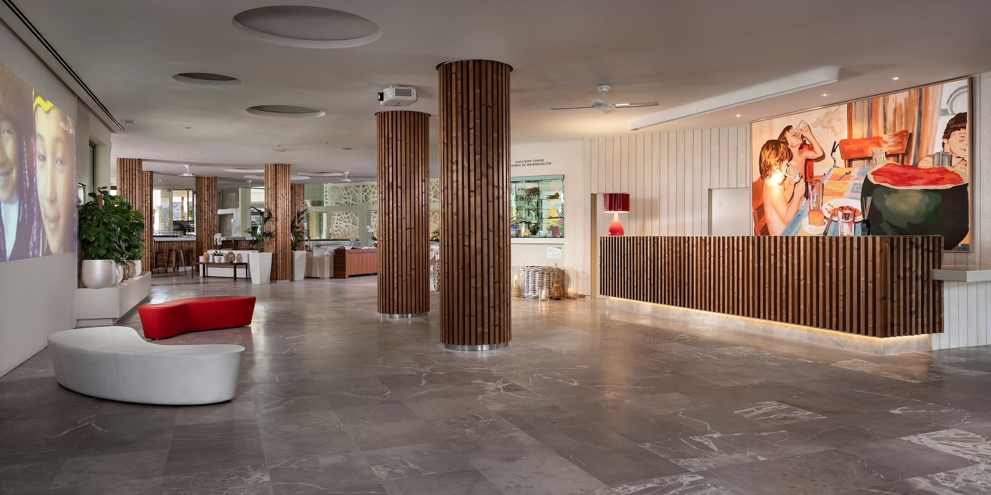 a lobby with columns and a couple of people