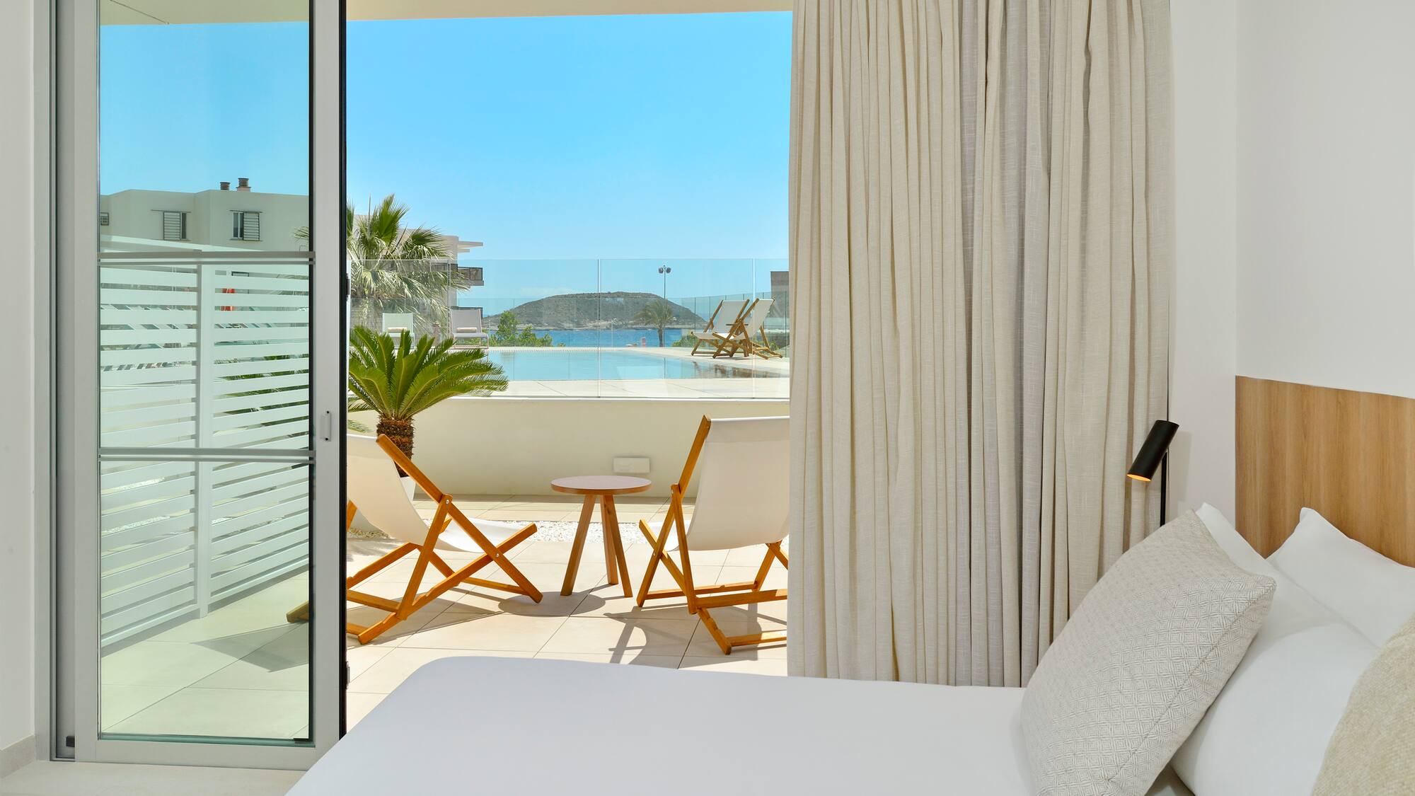 a bed with a table and chairs outside of a room